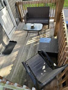 a patio with two chairs and a bench on a deck at *Cozy, Convenient Boston. Indulge, you deserve it* in Boston