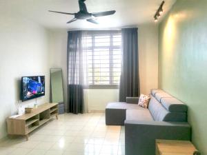 uma sala de estar com um sofá e uma ventoinha de tecto em Putatan Platinum Apartment with Pool em Kota Kinabalu