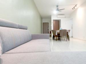a living room with a couch and a dining table at Putatan Platinum Apartment with Pool in Kota Kinabalu