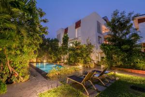 an image of a villa with a swimming pool at night at HideAway 2BHK Duplex Villa, North Goa (STU) in Mapusa