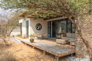 a patio of a house with a brick wall at Villa Lanterfant - luxury stay in nature - solar powered in Hoedspruit