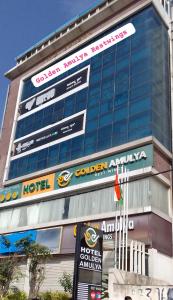 a large building with many signs in front of it at GOLDEN AMULYA REST WINGS in Yelahanka
