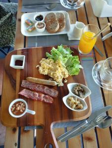 a wooden table with a tray of food on it at Lazy Republique in Ko Chang