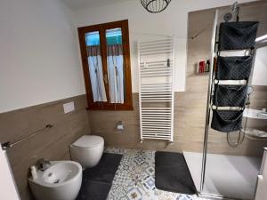 a bathroom with a toilet a sink and a shower at Il Castello di Alberico in Cotignola