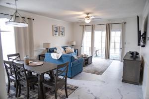 a living room with a blue couch and a table at Gorgeous Condo on Golf Course Near Broadway at the Beach in Myrtle Beach