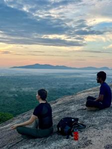 a man and a woman sitting on top of a mountain at Grand freedom in Sigiriya