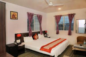 En eller flere senger på et rom på ASIAN INTERNATIONAL HOTEL, SANGLI