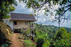 a house on a hill with a dirt road next to it at Garden Terrace Bali in Gobleg