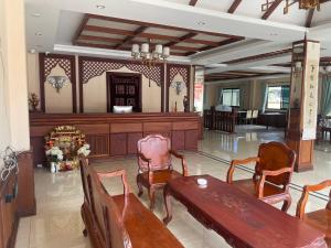 a lobby with tables and chairs in a building at Thavixay Hotel in Vientiane