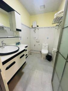 a bathroom with a sink and a shower and a toilet at Thavixay Hotel in Vientiane