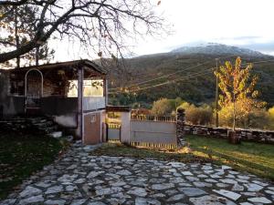a house with a gate and a mountain in the background at Residence "Ana Pletvarska" in Prilep