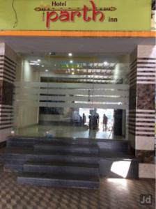a lobby of a hotel with stairs in a building at Hotel Parth Inn, WARDHA in Wardha