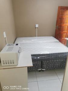 a room with a bed and a laptop on a table at Kpt property investment in Soweto