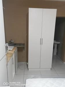 a white cabinet in a kitchen with a sink at Kpt property investment in Soweto