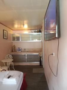 a bathroom with a tub and a tv on a wall at TerisitaPlace - LoveAtFirst in Taytay