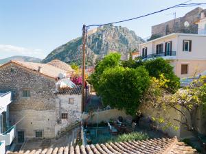 a view of a village with a mountain in the background at Theros Cottage - garden & sea breeze in Nafplio