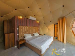 a bedroom with a large bed in a tent at wadi rum,Rania camp in Wadi Rum