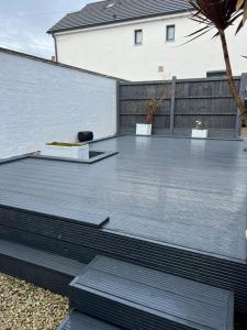 a metal patio with two chairs on top of it at Glendale Gardens Apartment in Southend-on-Sea