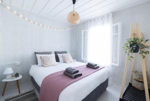a bedroom with a bed with towels on it at Theros Cottage - garden & sea breeze in Nafplio