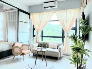 a living room with a couch and a table at J' Stay Jesselton Quay City Centre 邻近码头 in Kota Kinabalu