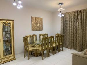 a dining room with a table and chairs at 2BR W Pool-20 min to DXB APT & Dubai Mall in Dubai
