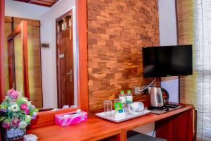 a hotel room with a desk with a television on it at Uma Garden Kandegedara in Matugama