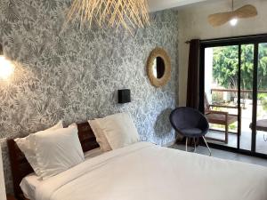Кровать или кровати в номере Ikopa Hôtel Madagascar