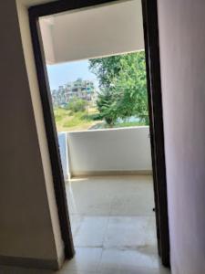 een open deur met uitzicht op een balkon bij Two Brother's Hotel lodging And Restaurant WARDHA in Wardha
