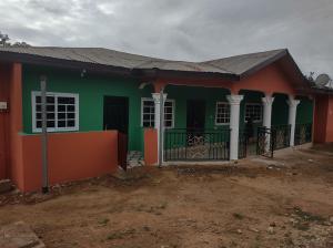 a house with a green and orange at Kingee Lodge in Sunyani