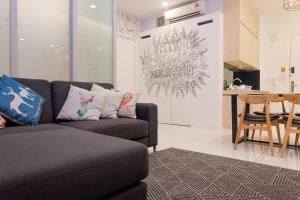 a living room with a couch and a table at The Robertson Bukit Bintang by Wowhome in Kuala Lumpur