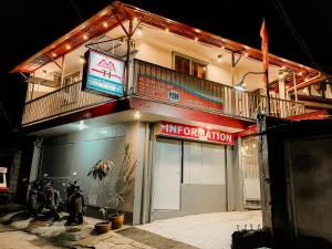 a building with a sign that reads immigration at Mario's Travellers Inn in Coron