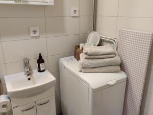 a bathroom with a sink and a washing machine at Studio Porin Karhu, home away home in Pori city center, free parking in Pori