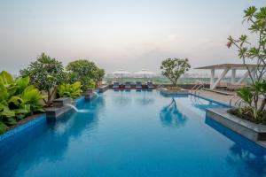a pool at a hotel with blue water at Radisson Blu Pune Hinjawadi in Pune