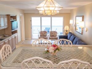 a kitchen and living room with a table and chairs at Deluxe Ocean View Villas - Just Steps From White Sand Beaches in Creek Village