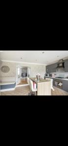 a kitchen with a table and chairs in a room at Beautiful Views Welsh Valley home in Mountain Ash