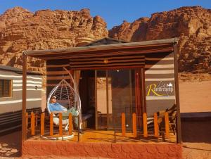 a man sitting in a hammock in a tiny house at wadi rum,Rania camp in Wadi Rum