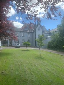 a large white house with two trees in the yard at Presentation Convent in Mooncoin