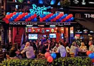 a group of people sitting at a bar with balloons at 2BR Tourists-Friendly Oasis - Heart of the City KL by Verano in Kuala Lumpur +25 photos