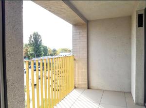 balkon z żółtą bramą i parkingiem w obiekcie Apartamenty Fuzja - Komfortowe Mieszkania Blisko Centrum Łodzi w Łodzi