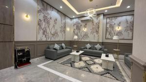 a living room with couches and a fireplace at Qimam Park Alnamas 6 in Al Namas