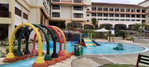 a swimming pool with a playground in a hotel at Amverton Heritage Resort in Melaka