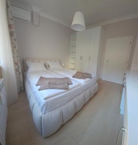 a large white bed in a room with white cabinets at Tsar Asen 21 in Sofia