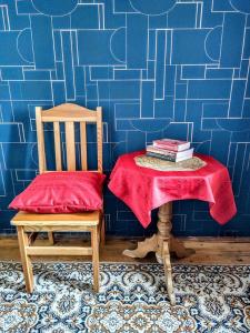 a room with two chairs and a table with books at Hostel Retro in Kraków