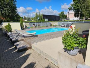 a swimming pool with a bench and a table at "Summer" apartment in Viljandi