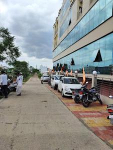 a group of cars parked next to a building at Hotel Hariram Tower,Wardha in Wardha