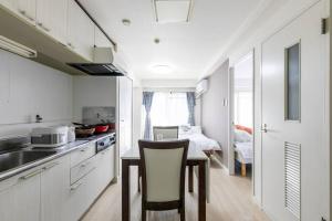 a kitchen with a table with a chair and a room at Shinkoiwa Sta 5min!  Free Wi-Fi! Max 5 people. in Tokyo