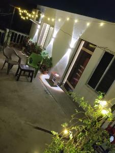 a patio with a table and chairs at night at Urban Sky in Shānti Niketan