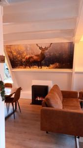 a living room with a couch and a fireplace at de bosdriehoek II in Durbuy