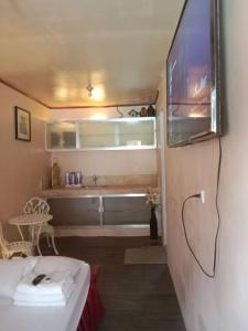 a living room with a couch and a tv on a wall at TerisitaPlace - LoveAtFirst in Taytay