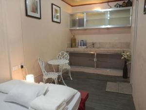 a bedroom with a bed and a table and a sink at TerisitaPlace - LoveAtFirst in Taytay